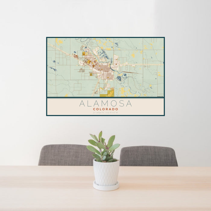 24x36 Alamosa Colorado Map Print Lanscape Orientation in Woodblock Style Behind 2 Chairs Table and Potted Plant