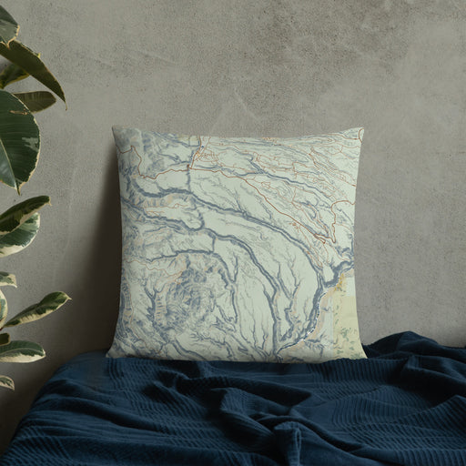 Custom Bandelier National Monument Map Throw Pillow in Woodblock on Bedding Against Wall