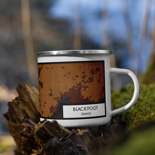 Right View Custom Blackfoot Idaho Map Enamel Mug in Ember on Grass With Trees in Background