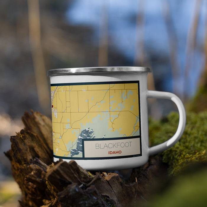 Right View Custom Blackfoot Idaho Map Enamel Mug in Woodblock on Grass With Trees in Background