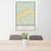 24x36 Bloomfield New Mexico Map Print Portrait Orientation in Woodblock Style Behind 2 Chairs Table and Potted Plant