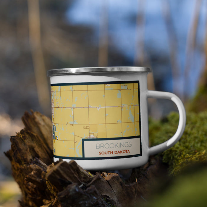 Right View Custom Brookings South Dakota Map Enamel Mug in Woodblock on Grass With Trees in Background
