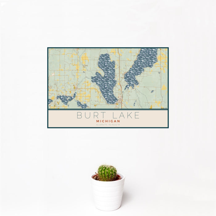 12x18 Burt Lake Michigan Map Print Landscape Orientation in Woodblock Style With Small Cactus Plant in White Planter