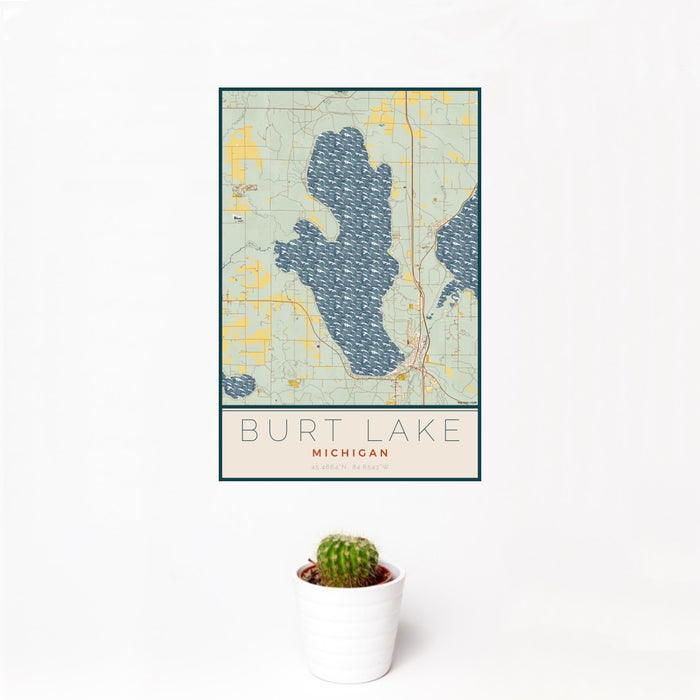 12x18 Burt Lake Michigan Map Print Portrait Orientation in Woodblock Style With Small Cactus Plant in White Planter