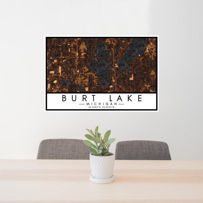 24x36 Burt Lake Michigan Map Print Landscape Orientation in Ember Style Behind 2 Chairs Table and Potted Plant