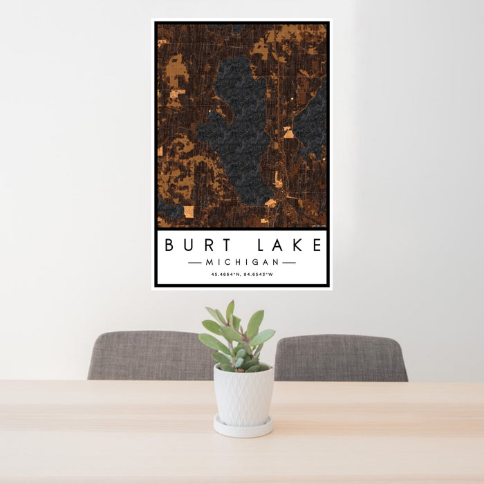 24x36 Burt Lake Michigan Map Print Portrait Orientation in Ember Style Behind 2 Chairs Table and Potted Plant