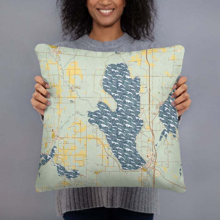 Person holding 18x18 Custom Burt Lake Michigan Map Throw Pillow in Woodblock