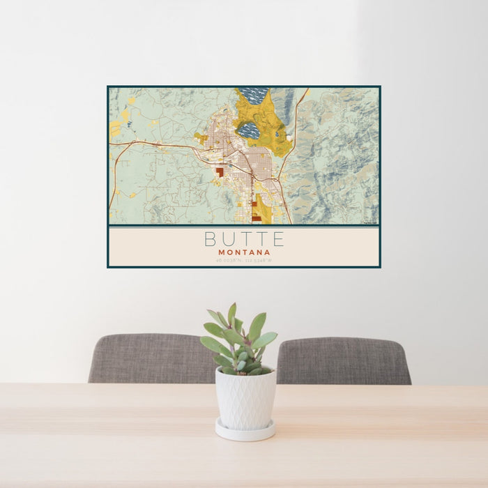 24x36 Butte Montana Map Print Lanscape Orientation in Woodblock Style Behind 2 Chairs Table and Potted Plant