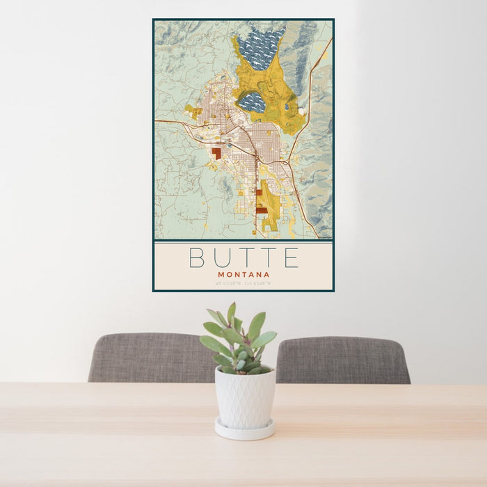 24x36 Butte Montana Map Print Portrait Orientation in Woodblock Style Behind 2 Chairs Table and Potted Plant