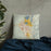 Custom Butte Montana Map Throw Pillow in Woodblock on Bedding Against Wall