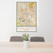 24x36 Calgary Alberta Map Print Portrait Orientation in Woodblock Style Behind 2 Chairs Table and Potted Plant