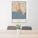 24x36 Cannes France Map Print Portrait Orientation in Woodblock Style Behind 2 Chairs Table and Potted Plant