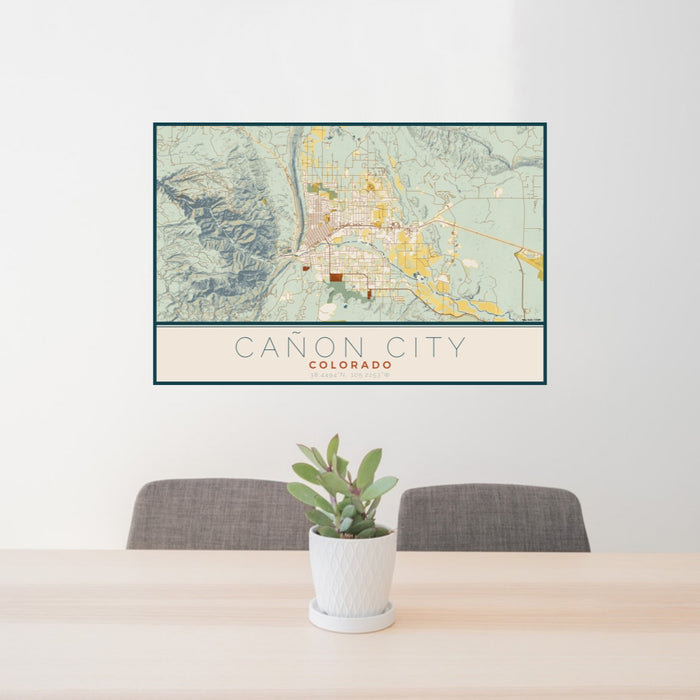 24x36 Cañon City Colorado Map Print Lanscape Orientation in Woodblock Style Behind 2 Chairs Table and Potted Plant