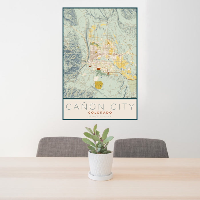 24x36 Cañon City Colorado Map Print Portrait Orientation in Woodblock Style Behind 2 Chairs Table and Potted Plant