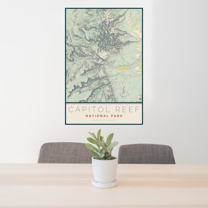 24x36 Capitol Reef National Park Map Print Portrait Orientation in Woodblock Style Behind 2 Chairs Table and Potted Plant