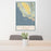 24x36 Central Coast California Map Print Portrait Orientation in Woodblock Style Behind 2 Chairs Table and Potted Plant