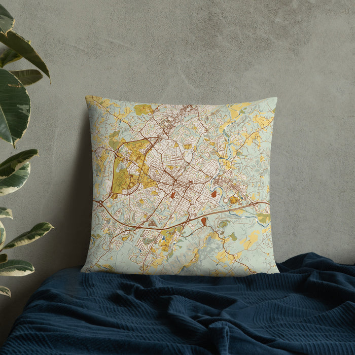 Custom Charlottesville Virginia Map Throw Pillow in Woodblock on Bedding Against Wall