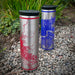 Two 17oz Stainless Steel Insulated Tumblers in red and in purple map colors on rocks