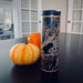 17oz Stainless Steel Insulated Tumbler with orange map on table with pumpkins