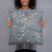 Person holding 18x18 Custom Cirque of the Towers Wyoming Map Throw Pillow in Afternoon