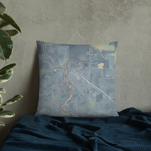 Custom Cut Bank Montana Map Throw Pillow in Afternoon on Bedding Against Wall