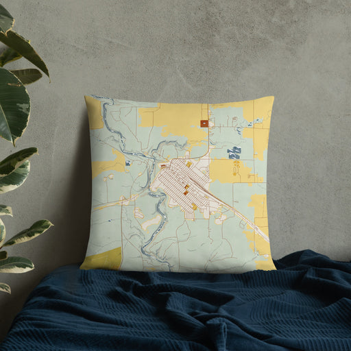 Custom Cut Bank Montana Map Throw Pillow in Woodblock on Bedding Against Wall