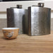 Pair of 6oz Stainless Steel Flask with Custom Engraved Map on Table Next To Sake Cup