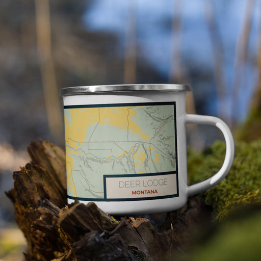 Right View Custom Deer Lodge Montana Map Enamel Mug in Woodblock on Grass With Trees in Background