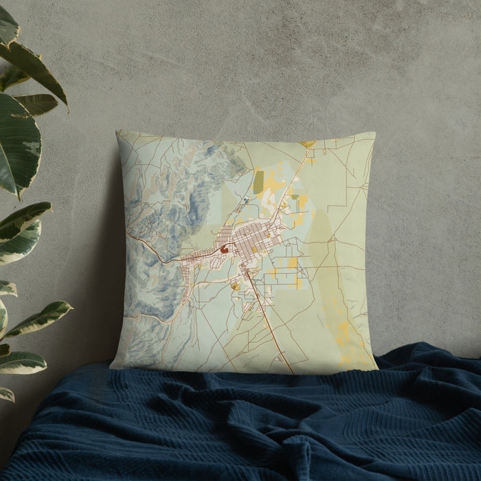 Custom Ely Nevada Map Throw Pillow in Woodblock on Bedding Against Wall