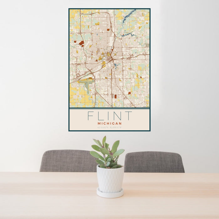 24x36 Flint Michigan Map Print Portrait Orientation in Woodblock Style Behind 2 Chairs Table and Potted Plant