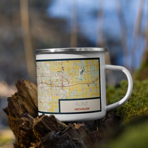 Right View Custom Flint Michigan Map Enamel Mug in Woodblock on Grass With Trees in Background