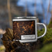 Right View Custom Framingham Massachusetts Map Enamel Mug in Ember on Grass With Trees in Background