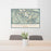 24x36 Fremont Peak Wyoming Map Print Lanscape Orientation in Woodblock Style Behind 2 Chairs Table and Potted Plant