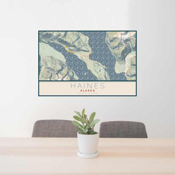 24x36 Haines Alaska Map Print Lanscape Orientation in Woodblock Style Behind 2 Chairs Table and Potted Plant