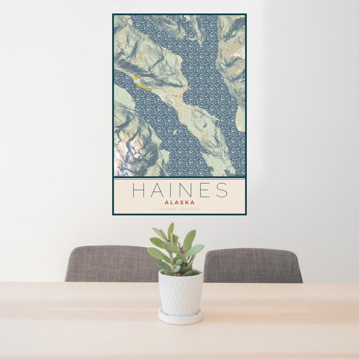 24x36 Haines Alaska Map Print Portrait Orientation in Woodblock Style Behind 2 Chairs Table and Potted Plant