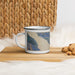 Left View Custom Haines Alaska Map Enamel Mug in Afternoon on Table Top