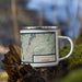 Right View Custom Half Moon Lake Wyoming Map Enamel Mug in Woodblock on Grass With Trees in Background