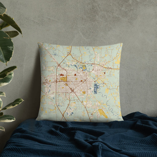Custom Hattiesburg Mississippi Map Throw Pillow in Woodblock on Bedding Against Wall