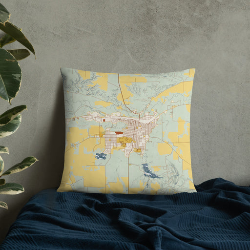 Custom Havre Montana Map Throw Pillow in Woodblock on Bedding Against Wall