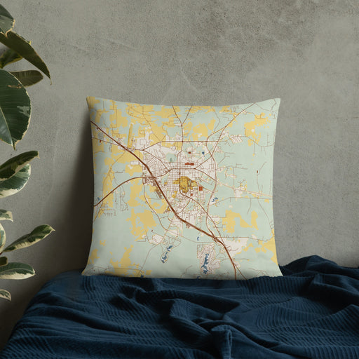 Custom Huntsville Texas Map Throw Pillow in Woodblock on Bedding Against Wall