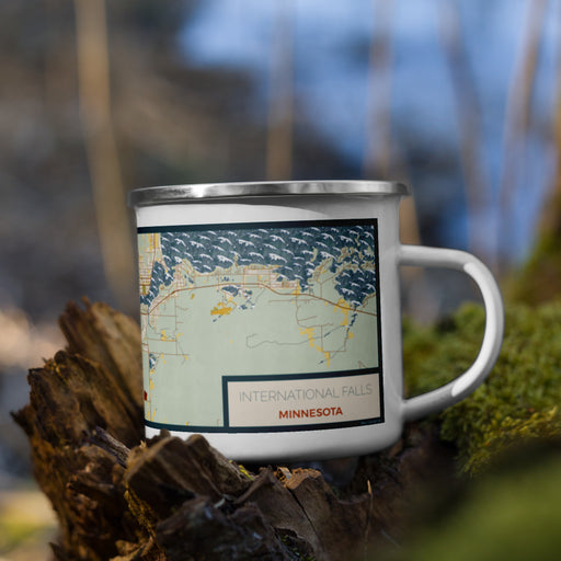 Right View Custom International Falls Minnesota Map Enamel Mug in Woodblock on Grass With Trees in Background