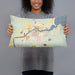 Person holding 20x12 Custom International Falls Minnesota Map Throw Pillow in Woodblock