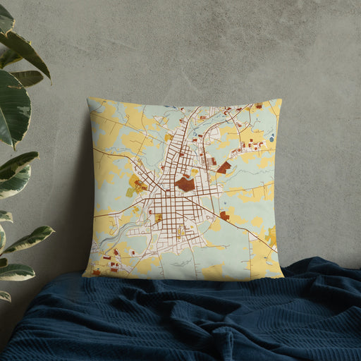 Custom Johnstown New York Map Throw Pillow in Woodblock on Bedding Against Wall