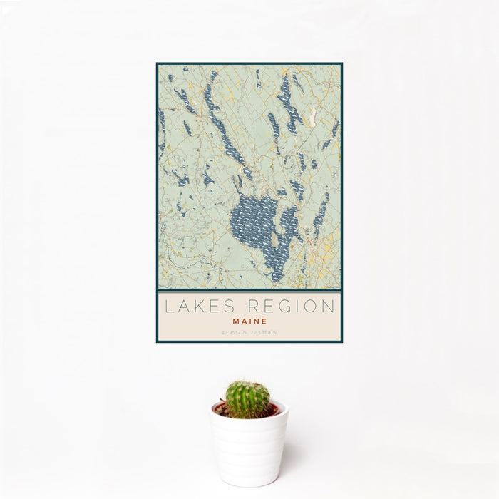 12x18 Lakes Region Maine Map Print Portrait Orientation in Woodblock Style With Small Cactus Plant in White Planter