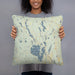 Person holding 18x18 Custom Lakes Region Maine Map Throw Pillow in Woodblock