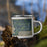 Right View Custom Lindstrom Minnesota Map Enamel Mug in Afternoon on Grass With Trees in Background