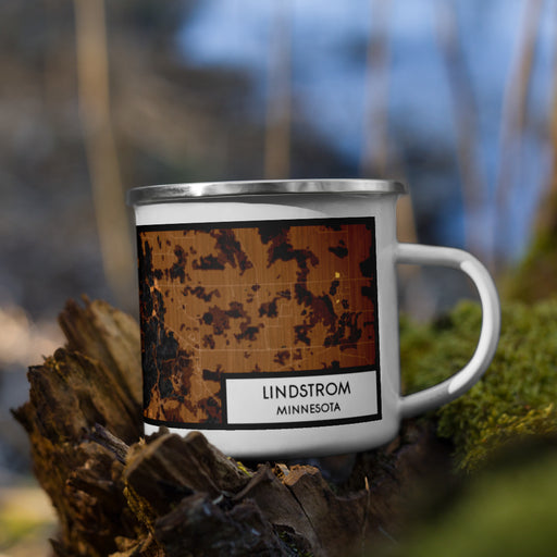 Right View Custom Lindstrom Minnesota Map Enamel Mug in Ember on Grass With Trees in Background