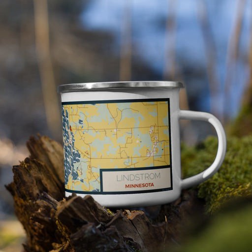 Right View Custom Lindstrom Minnesota Map Enamel Mug in Woodblock on Grass With Trees in Background