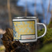 Right View Custom Lindstrom Minnesota Map Enamel Mug in Woodblock on Grass With Trees in Background