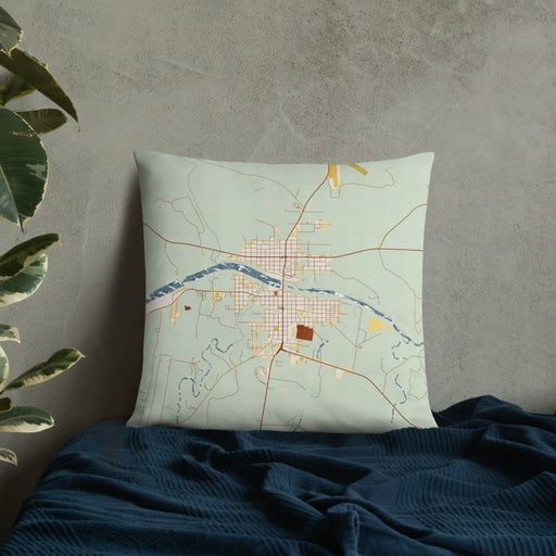 Custom Llano Texas Map Throw Pillow in Woodblock on Bedding Against Wall